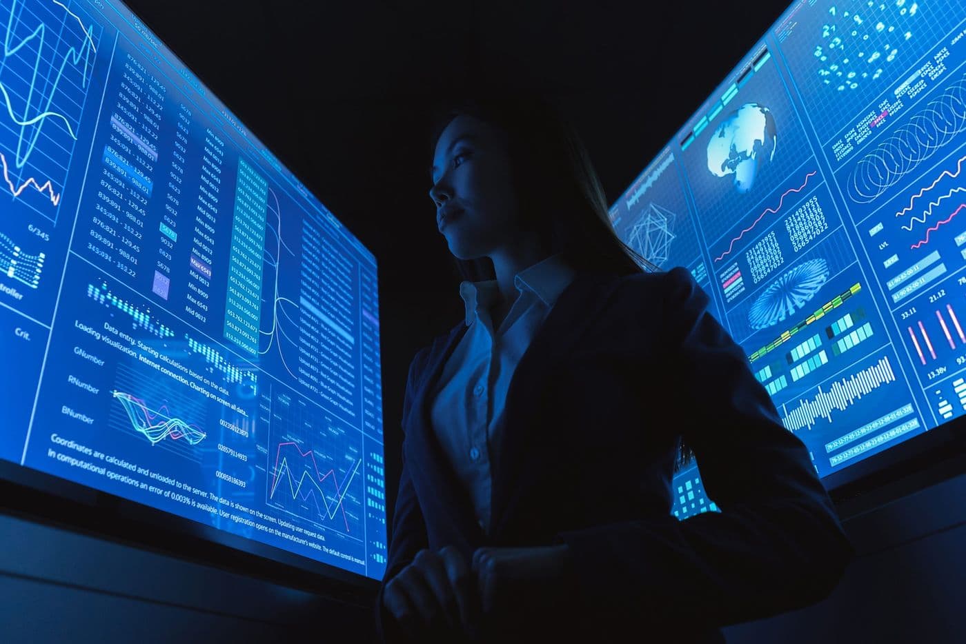 Analyst reading operational data across several screens