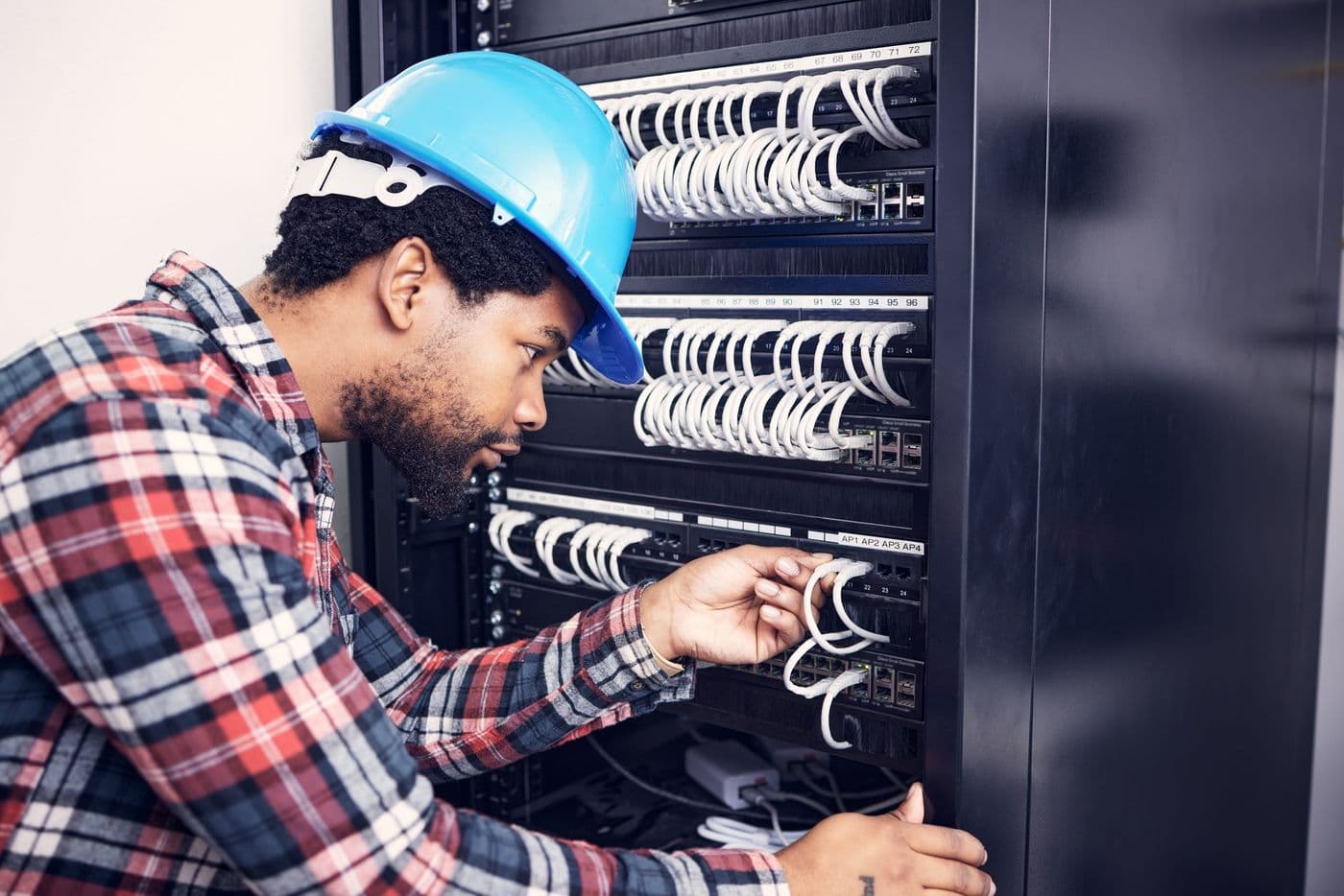 Engineer working on equipment in a server rack