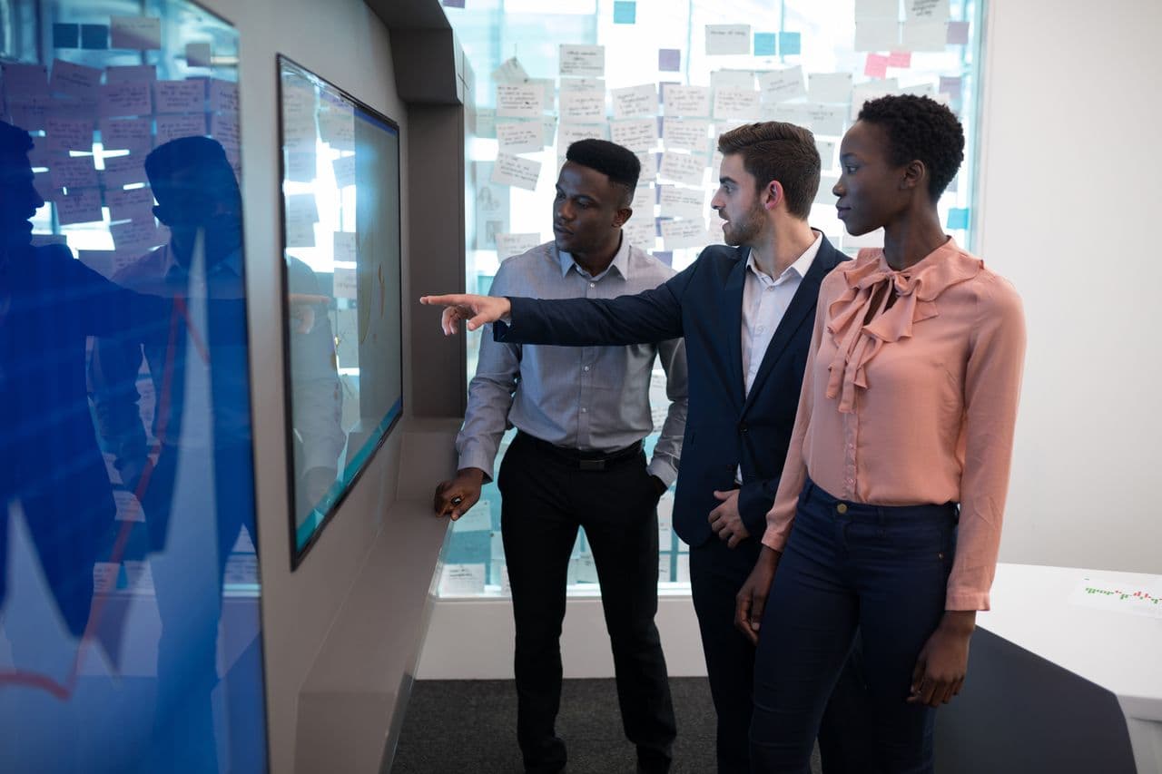 Team reviewing data on a large interactive screen
