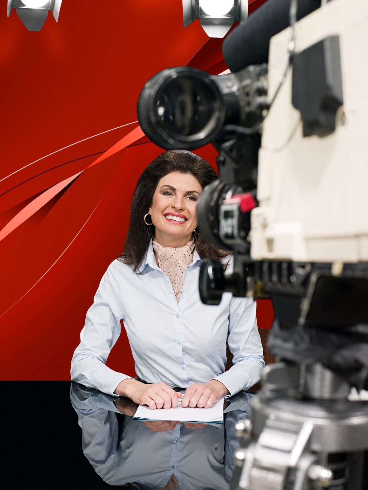 Presenter and studio camera in a broadcast studio