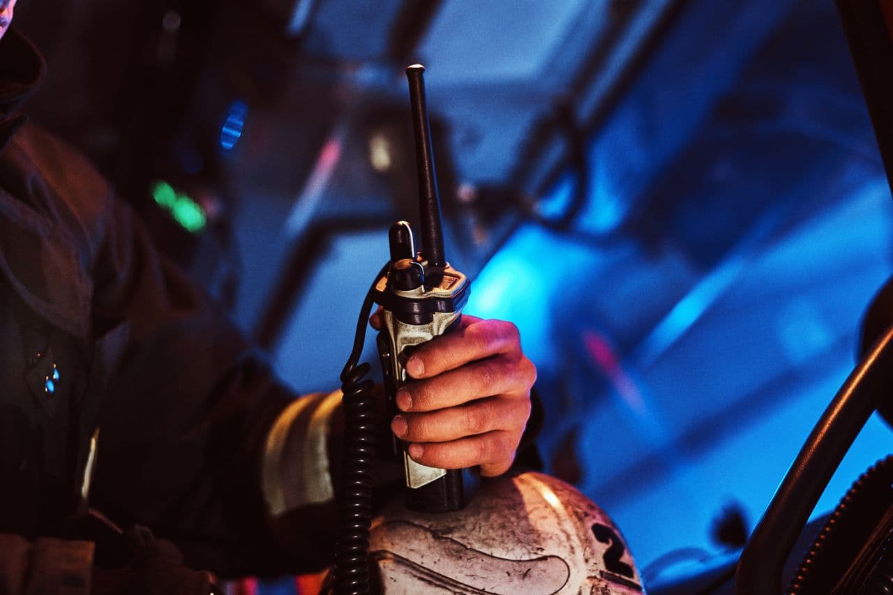 Firefighter holding a portable radio