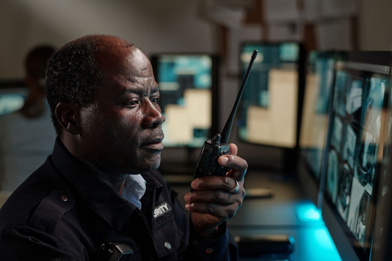 Operator monitoring camera feeds on a night shift