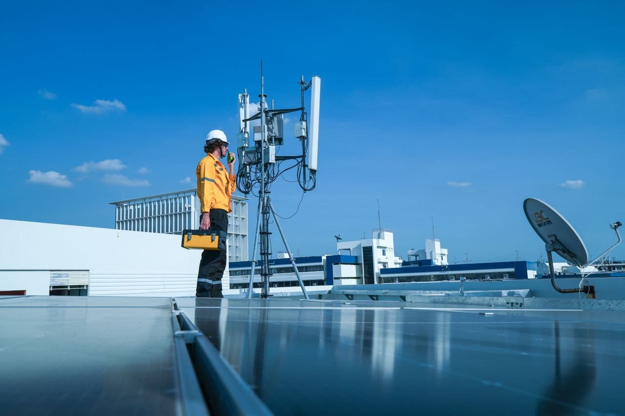 Technician inspecting rooftop radio equipment