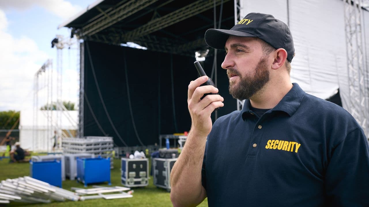 Security officer using a radio at an outdoor event