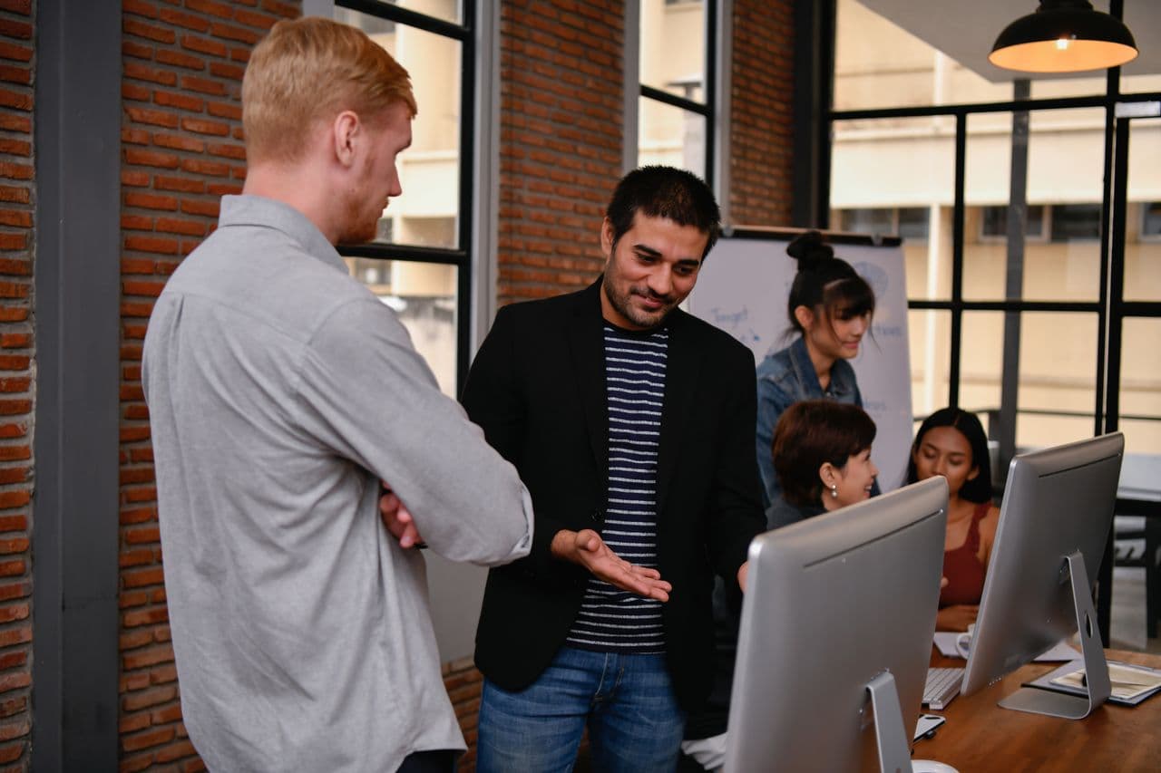 A new engineer working alongside an existing team at their desks
